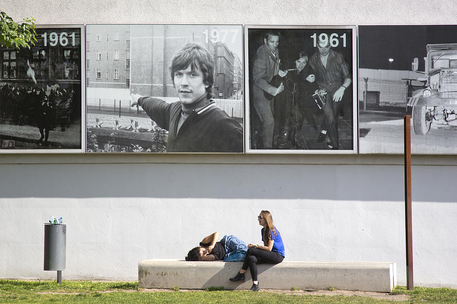 Two young people resting at the Bernauer Strasse memorial Photograph by Zenaphoto