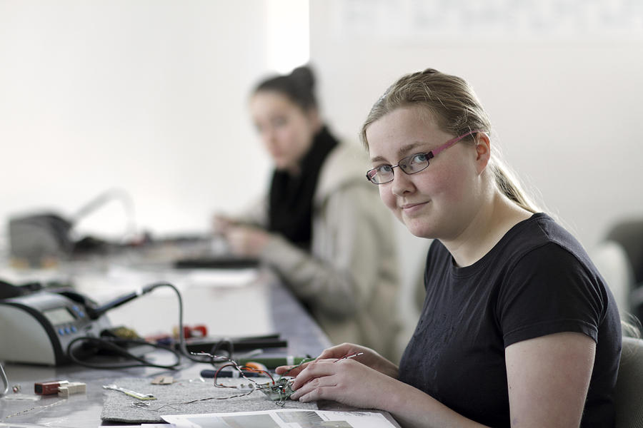 Two young women working on optical sensor in an electronic workshop Photograph by Westend61