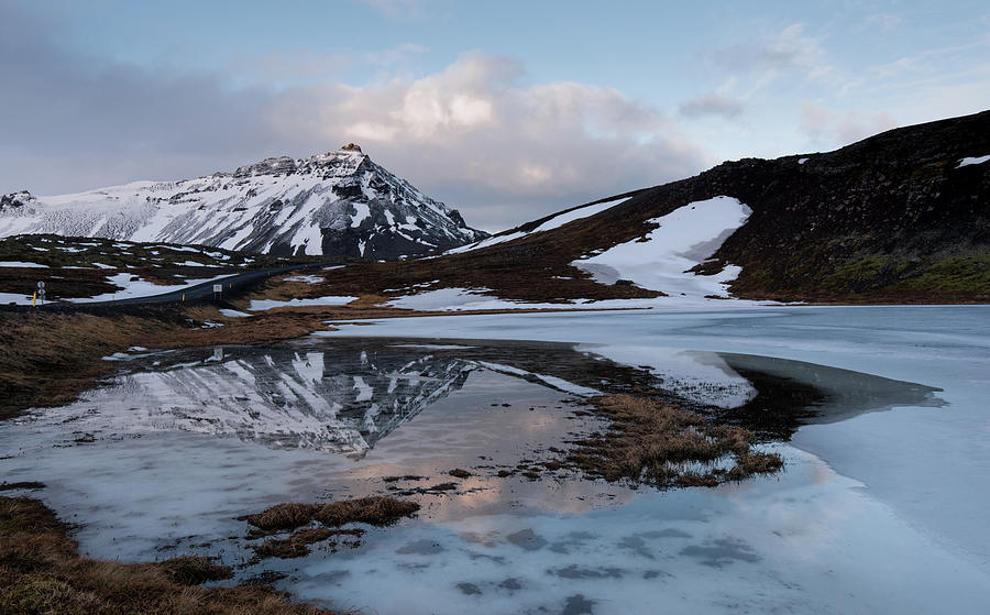 Typical Icelandic dramatic landscape with frozen lake and mountains covered in snow in Iceland Photograph by Michalakis Ppalis