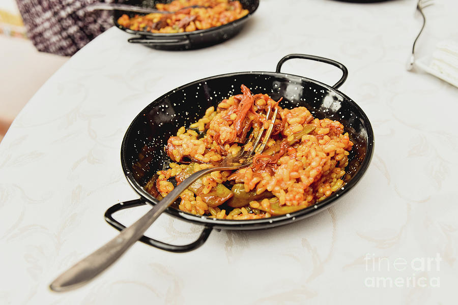 Typical valencian paella in a paella pan as an appetizer, traditional Spanish food. Photograph by Joaquin Corbalan