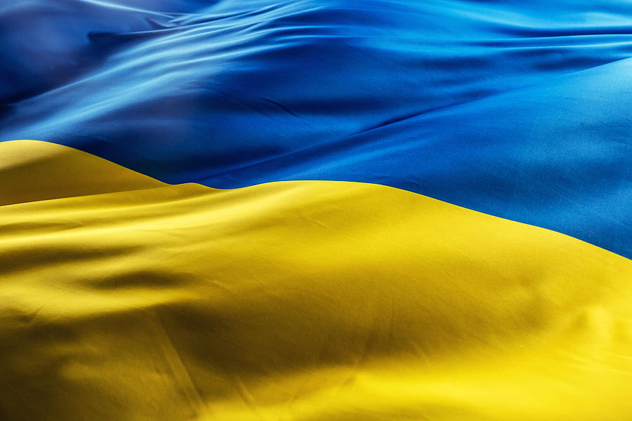 Ukrainian flag blowing in the morning light. Photograph by SimpleImages