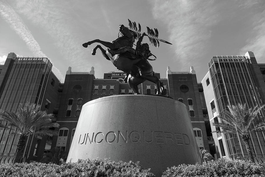 Unconquered statue in front of Doak Campbell Stadium at Florida State University in black and white Photograph by Eldon McGraw