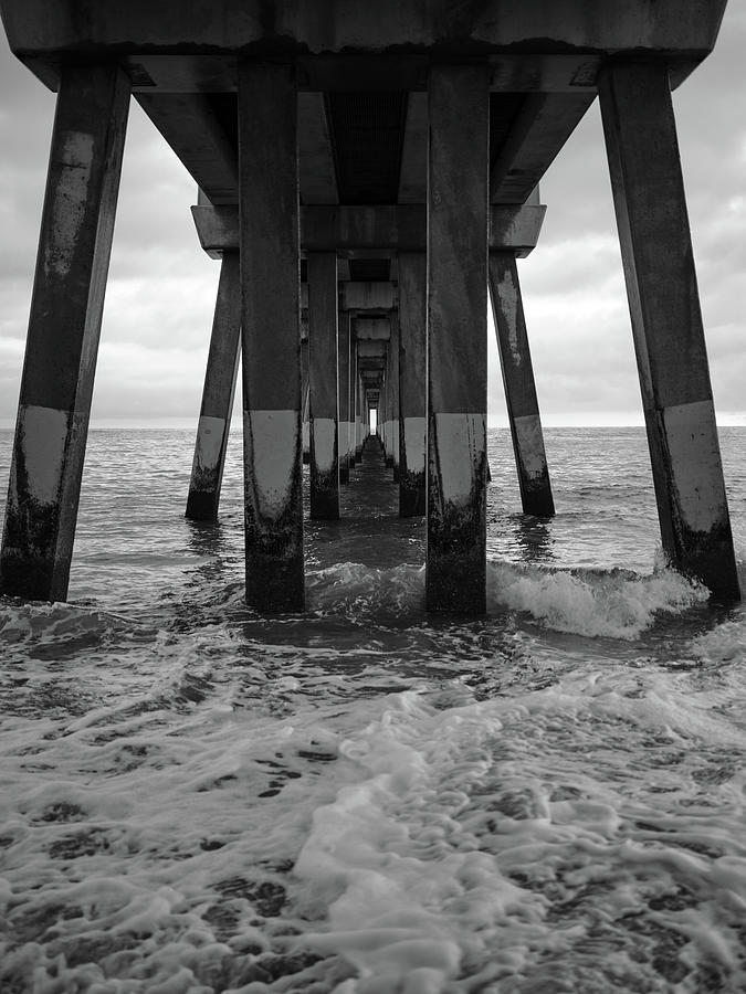 Under Jennettes Pier In Black and White Photograph by Doug Ash
