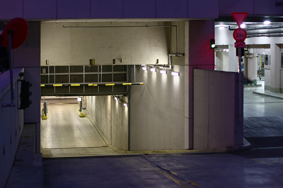 Underground Garage Entrance With Lights Inside At Night Photograph by ZoliMajor25