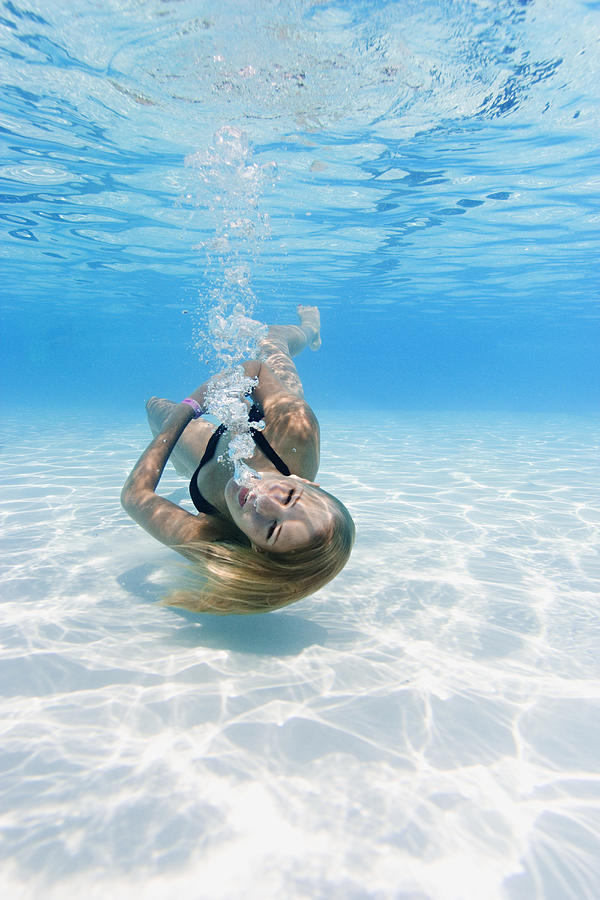Underwater Shot Of A Teenage Female As She Spins And Swims In A Pool Photograph by Photodisc