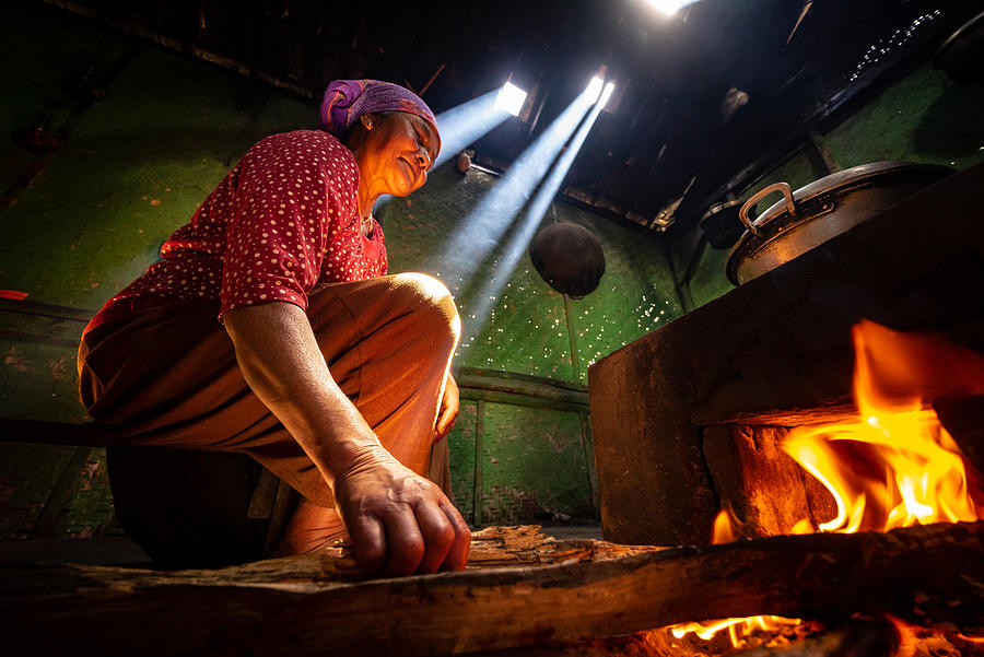Unidentified local lady preparing a lunch for family with traditional wood kitchen in Cemoro Lawang village of Bromo, East Java, Indonesia. Photograph by Shaifulzamri