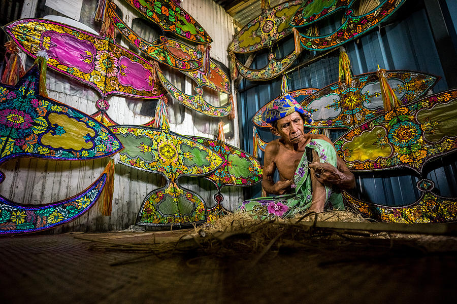 Unidentified man is making the traditional moon kite or locally known as Wau Bulan in Kelantan Photograph by Shaifulzamri