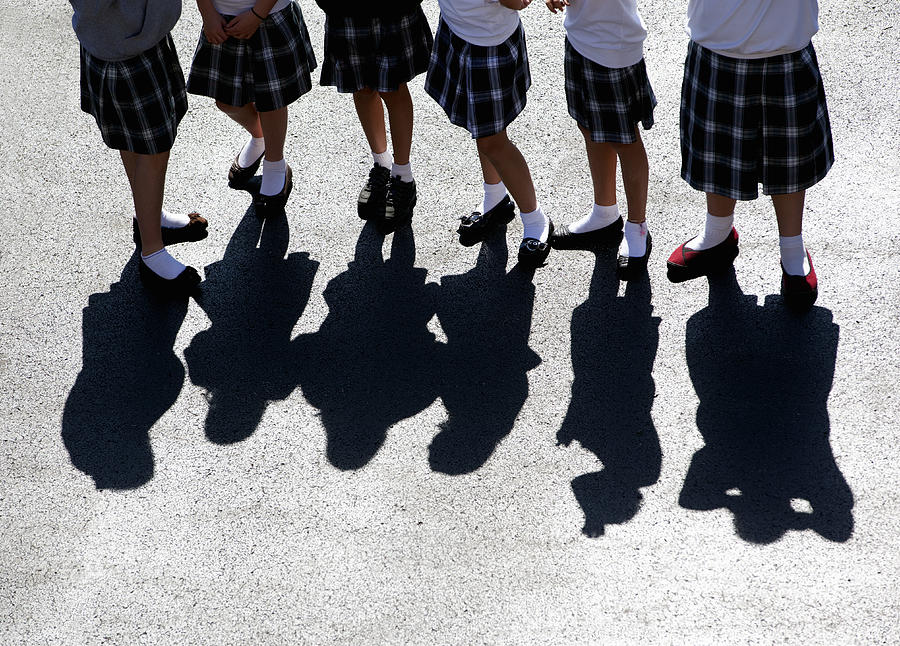 Uniformed Catholic school girls on the playground. Photograph by Jonathan Kirn