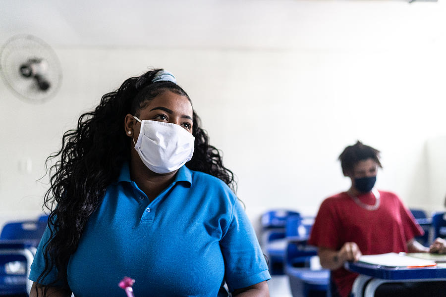 University / high school student wearing face mask while studying in the classroom Photograph by FG Trade