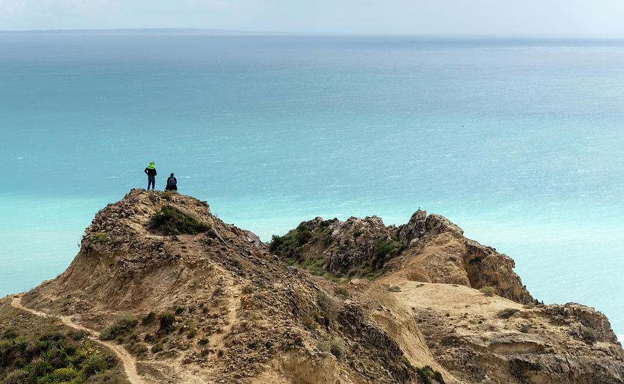 Standing At The Edge Of A Cliff Enjoying Sea. People Hiking Outdoors Photograph