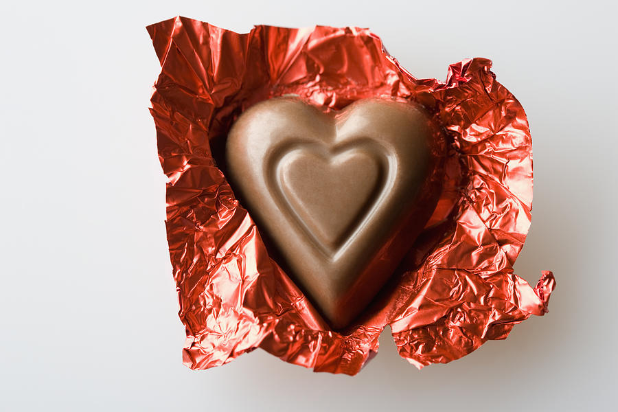 Unwrapped Valentines chocolate Photograph by Jose Luis Pelaez