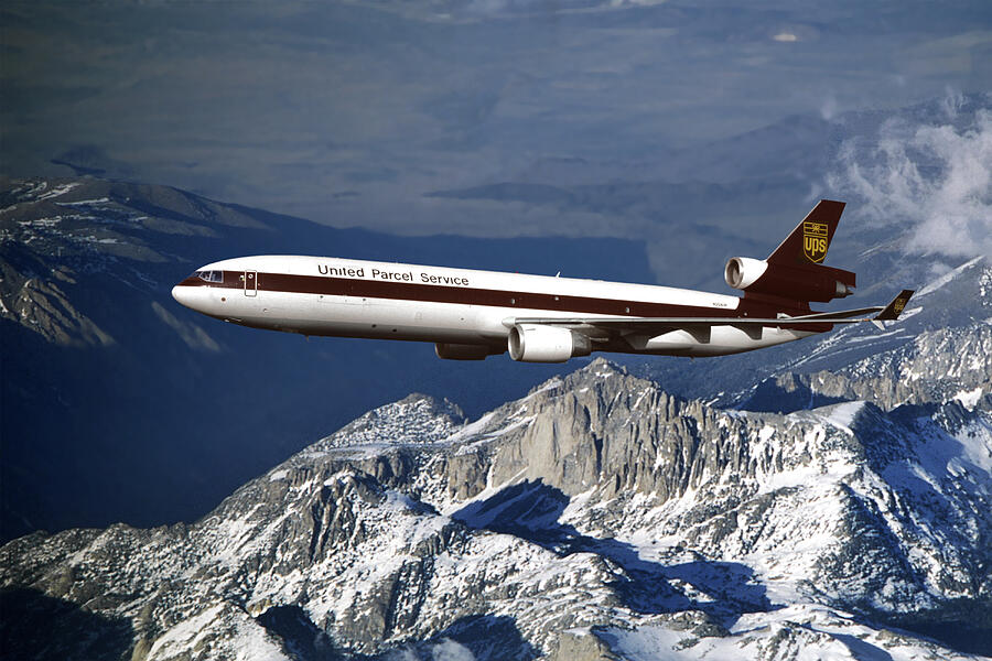 UPS MD-11F Over Snowcapped Mountains Mixed Media by Erik Simonsen