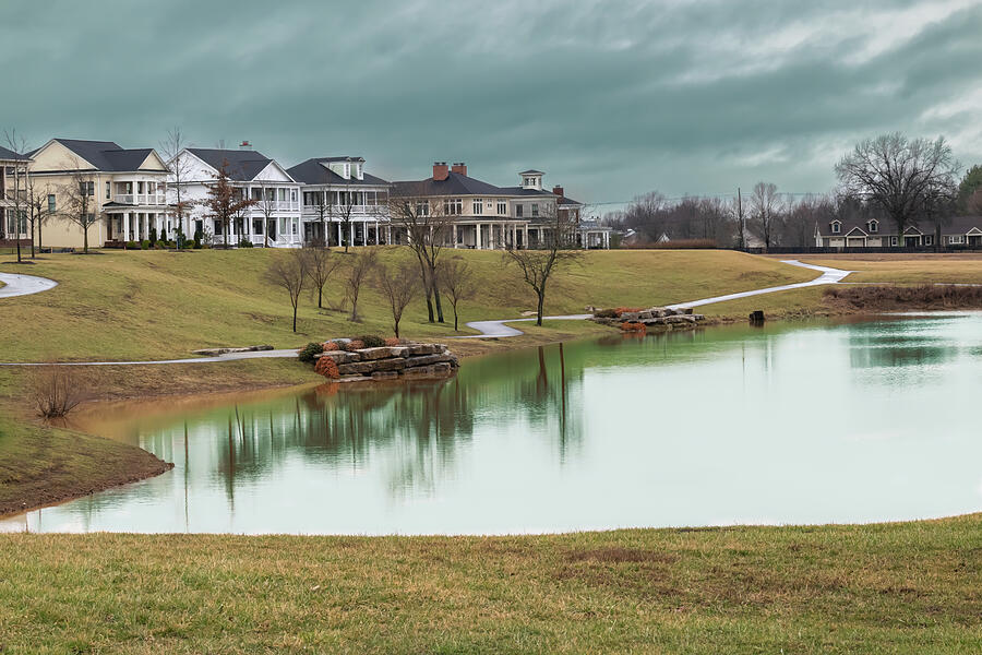 Upscale houses and neighborhood pond after a winter thunderstorm. Photograph by Mike Worley Upscale houses and neighborhood pond after a winter thunderstorm. Photograph by Mike Worley