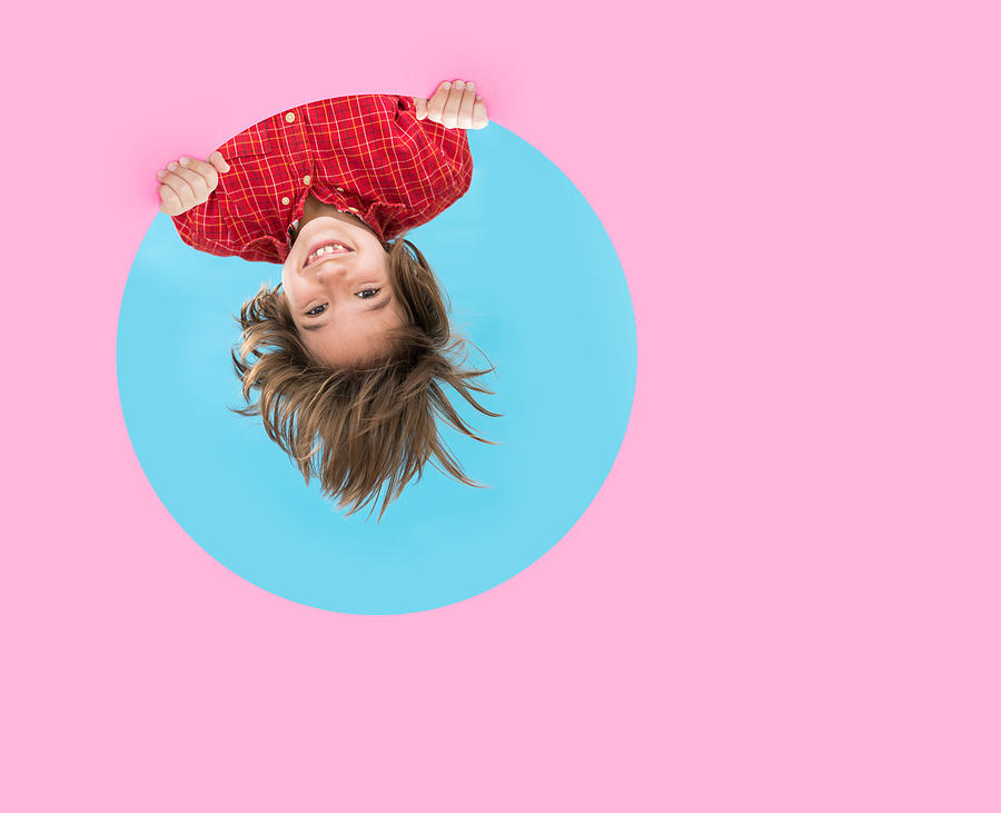Upside down child through pink blue circle Photograph by Jasmin Merdan