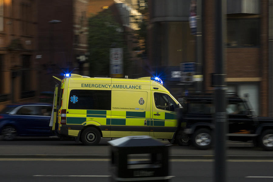 Urban city scene in Leeds, UK, Ambulance Photograph by Chris McLoughlin