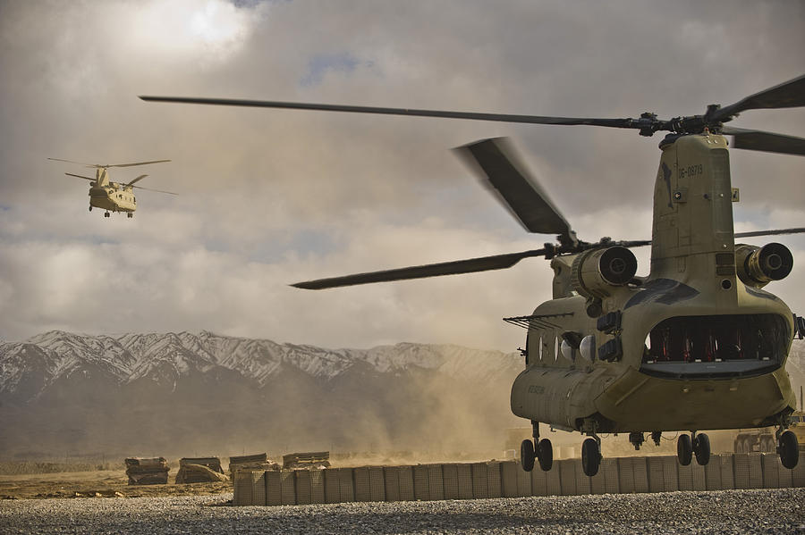 U.S. Army CH-47 Chinook helicopters depart a military base in Afghanistan. Photograph by Stocktrek Images