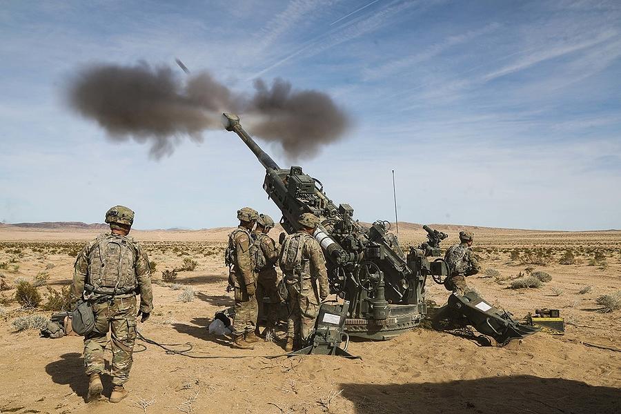 U.S. Army Soldiers fire an artillery round from an M777 Howitzer by US ...