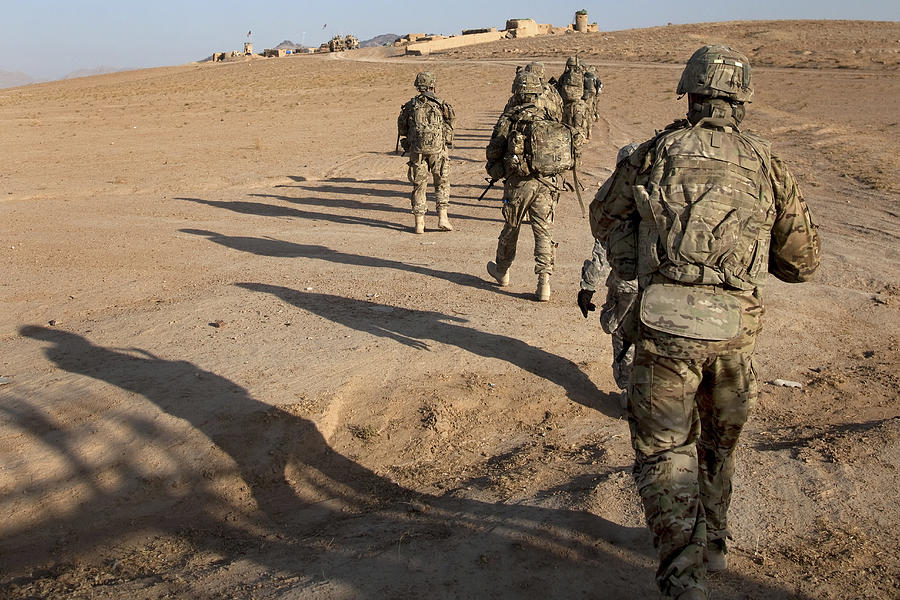 U.S. Army soldiers walk toward a checkpoint in Afghanistan. Photograph by Stocktrek Images