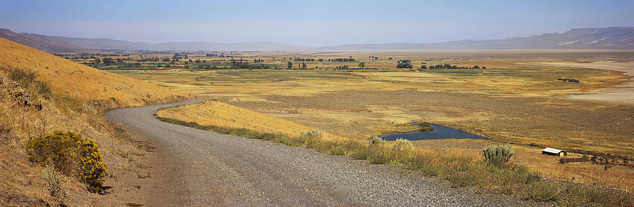 USA, California, near Eagleville, gravel road and Surprise Valley in background Photograph by Timothy Hearsum