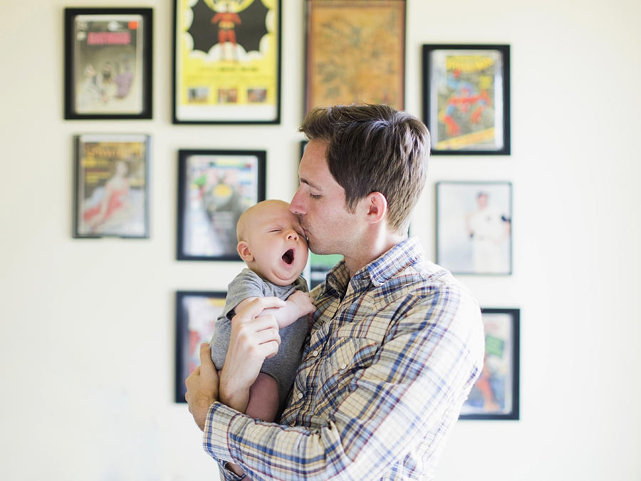 USA, California, Orange County, Father kissing baby son (2-5 months) Photograph by Tetra Images/Jessica Peterson