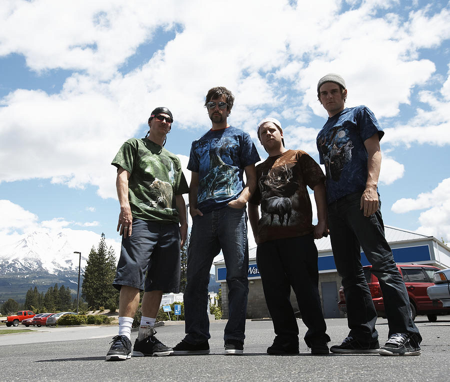 USA, California, Weed, four young men in parking lot at truck stop Photograph by Thomas Northcut