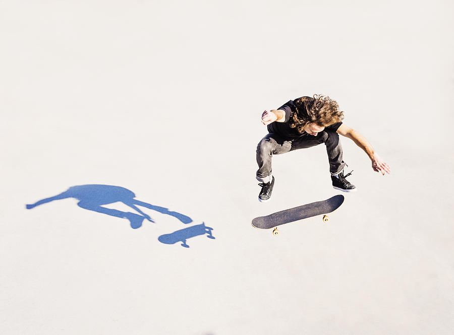 USA, Florida, West Palm Beach, Man jumping on skateboard in skatepark Photograph by Daniel Grill