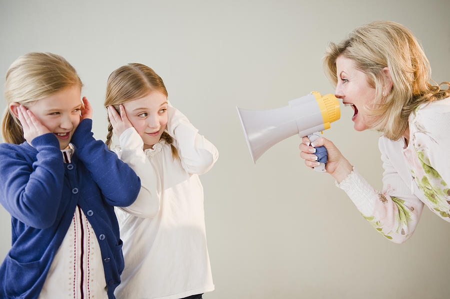 USA, Jersey City, New Jersey, mother shouting at daughters (8-11) through bullhorn Photograph by Jamie Grill Photography