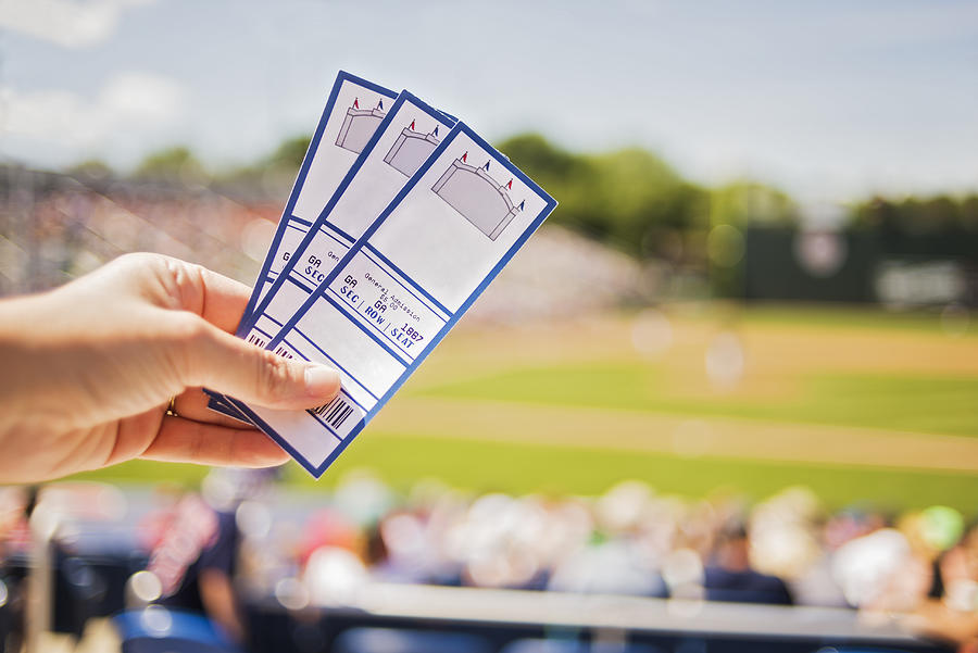 USA, Maine, Portland, Close-up of hand holding tickets at stadium Photograph by Daniel Grill/Tetra Images