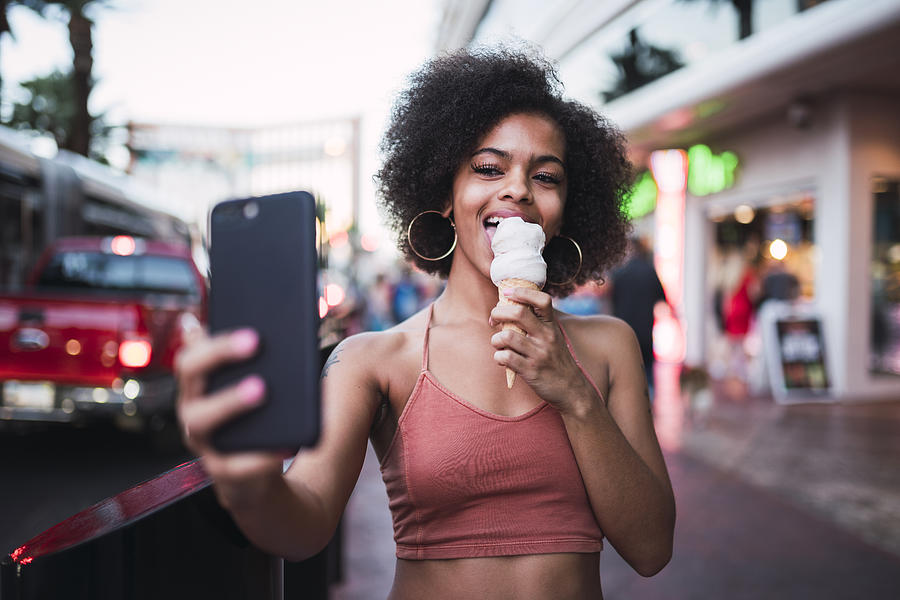 USA, Nevada, Las Vegas, happy young woman eating ice cream in the city taking a selfie Photograph by Westend61