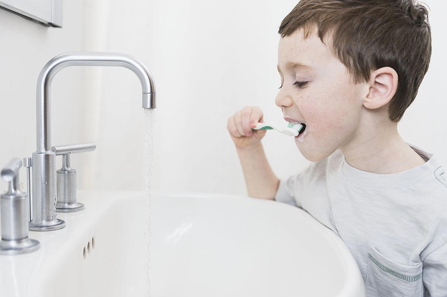 USA, New Jersey, Jersey City, Boy (6-7) brushing teeth Photograph by Tetra Images