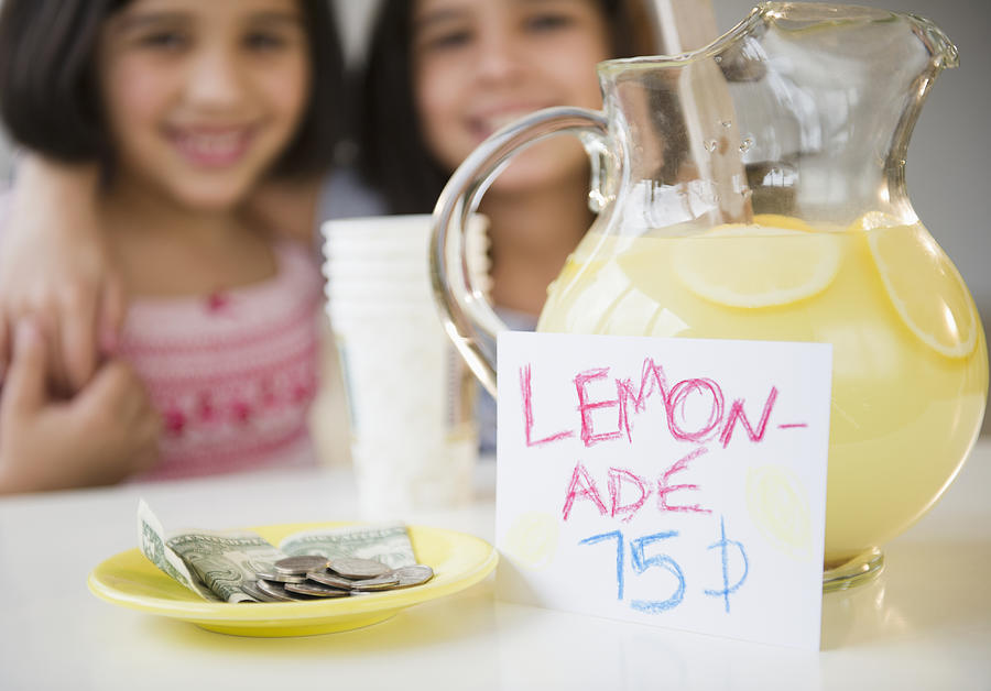 USA, New Jersey, Jersey City, Close up of two girls (8-9, 10-11) selling lemonade Photograph by Jamie Grill