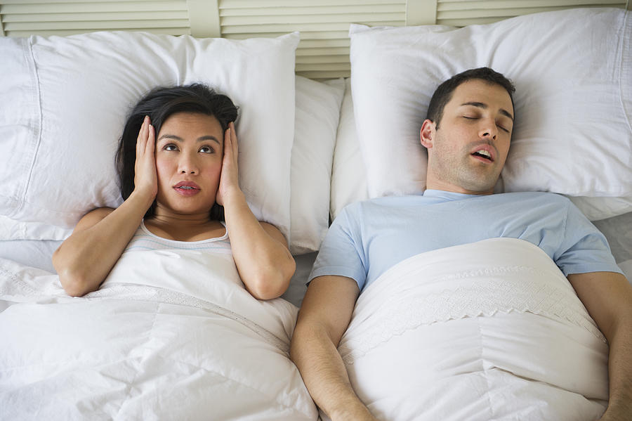 USA, New Jersey, Jersey City, Couple in bed, man snoring Photograph by Tetra Images