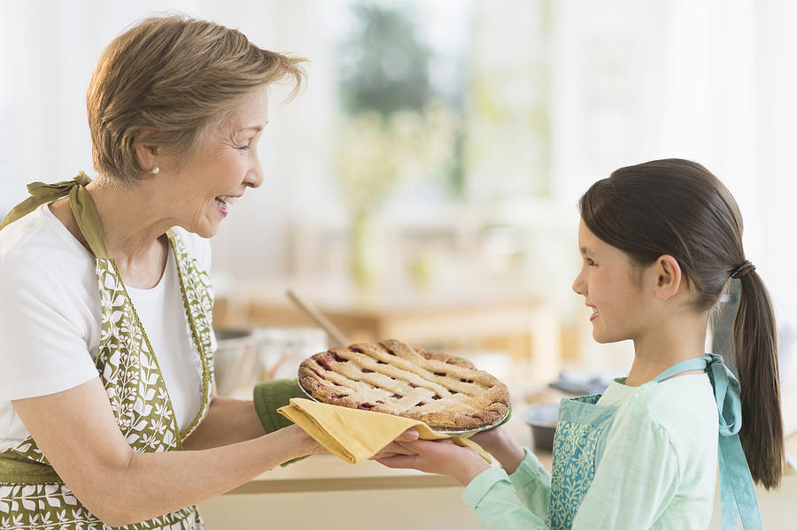 USA, New Jersey, Jersey City, Grandmother and granddaughter (8-9) holding freshly baked pie Photograph by Tetra Images
