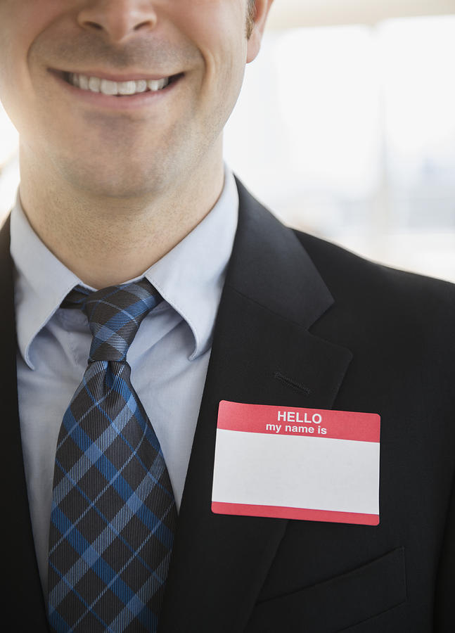 USA, New Jersey, Jersey City, Office worker with name tag on suit Photograph by Jamie Grill