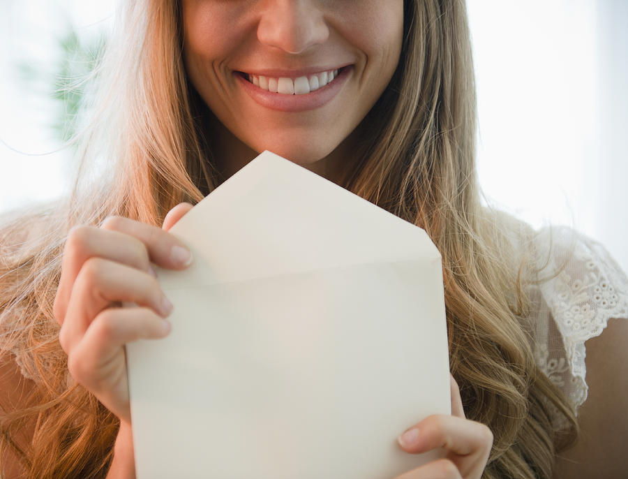 USA, New Jersey, Jersey City, Portrait of blonde woman holding envelope Photograph by Jamie Grill