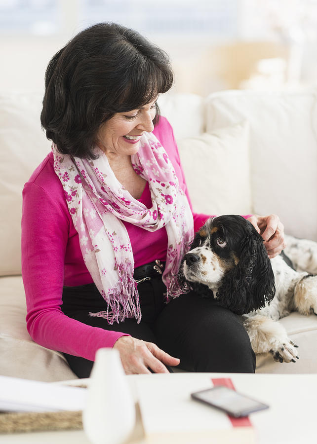 USA, New Jersey, Jersey City, Portrait of senior woman sitting on sofa with her dog Photograph by Tetra Images