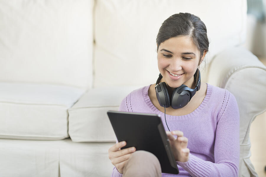 USA, New Jersey, Jersey City, Portrait of teenage girl (16-17) with digital tablet and headphones Photograph by Tetra Images