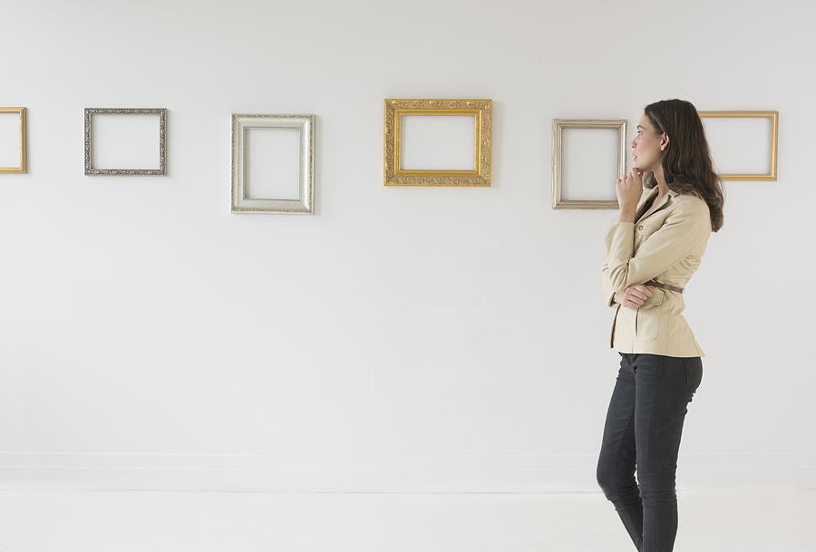 USA, New Jersey, Jersey City, Woman looking at blank pictures in art gallery Photograph by Tetra Images