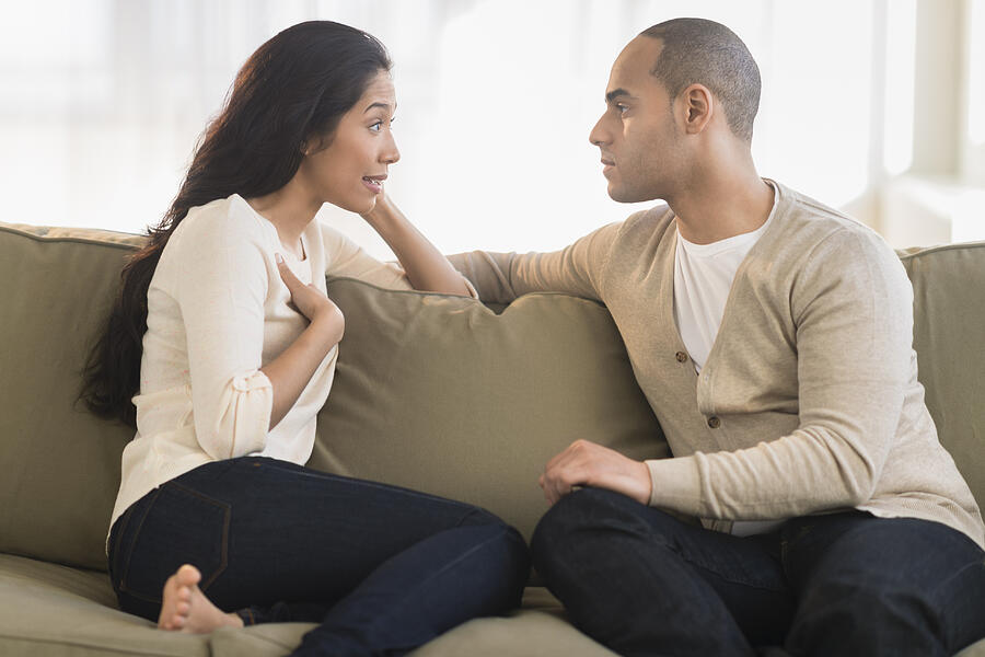 USA, New Jersey, Jersey City, Young couple sitting on couch Photograph by Tetra Images