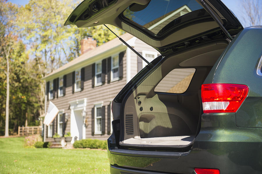 USA, New Jersey, Mendham, Open car trunk in front of house Photograph by Daniel Grill