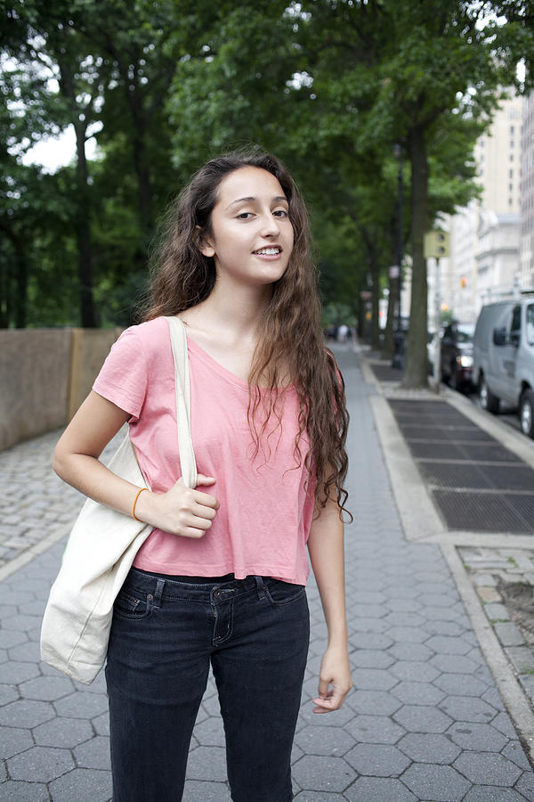 USA, New York, New York City, Portrait of smiling young woman standing on street Photograph by Winslow Productions