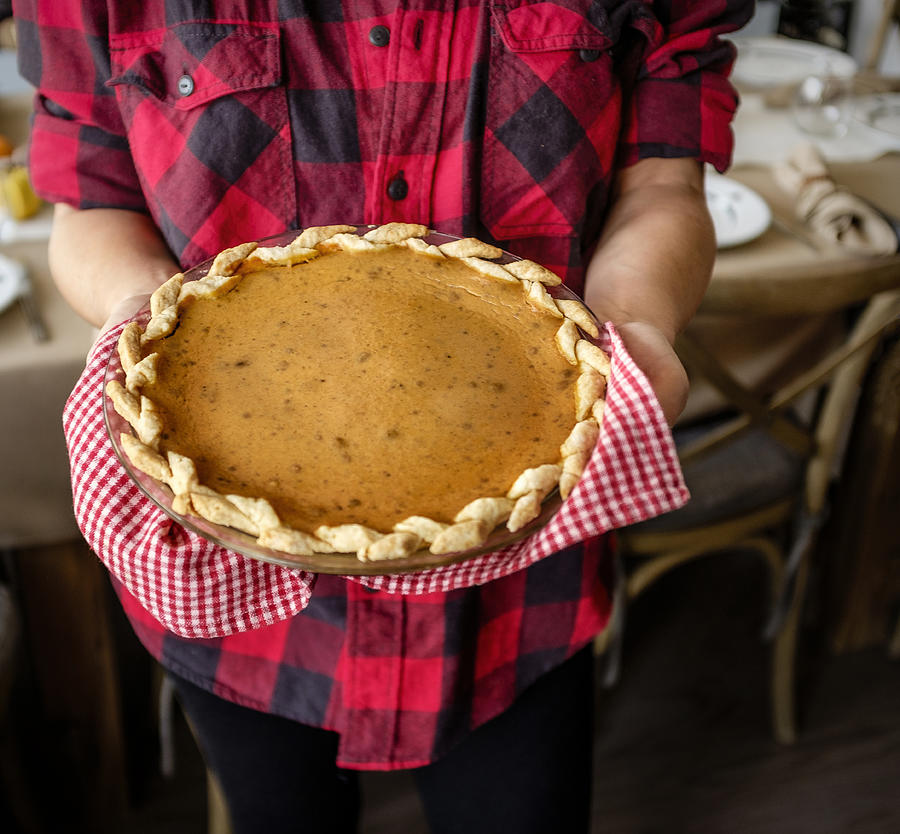 USA, New York State, New York City, Woman holding baked pumpkin pie for Thanksgiving Photograph by Tetra Images
