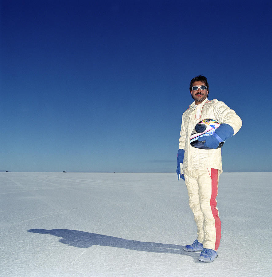 USA, Utah, Bonneville Salt Flats, racecar driver standing on raceway Photograph by Ryan McVay