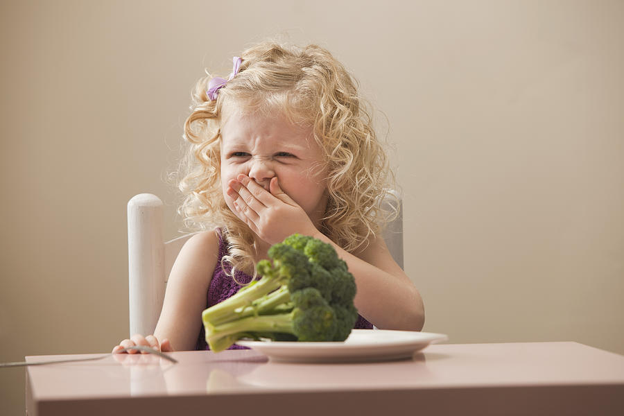 USA, Utah, Lehi, girl (2-3) disgusted with broccoli Photograph by Mike Kemp