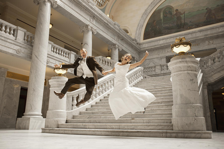 USA, Utah, Salt Lake City, Bride and groom leaping from steps Photograph by Fbp