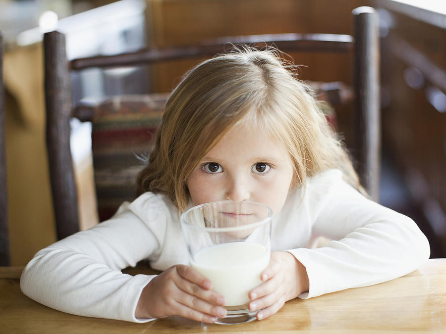 USA, Utah, Salt Lake City, girl (4-5) drinking milk in kitchen Photograph by Tetra Images - Jessica Peterson