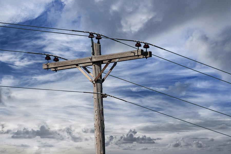 Utility Pole against a Cloudy Blue Sky Photograph by Randall Nyhof