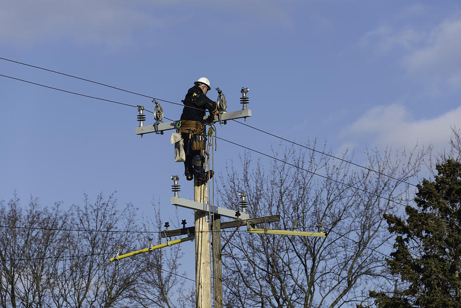 Utility Worker on Pole Photograph by RiverNorthPhotography