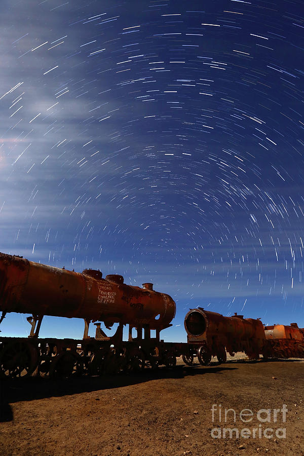 Uyuni train cemetery by moonlight and star trails Bolivia Photograph by James Brunker