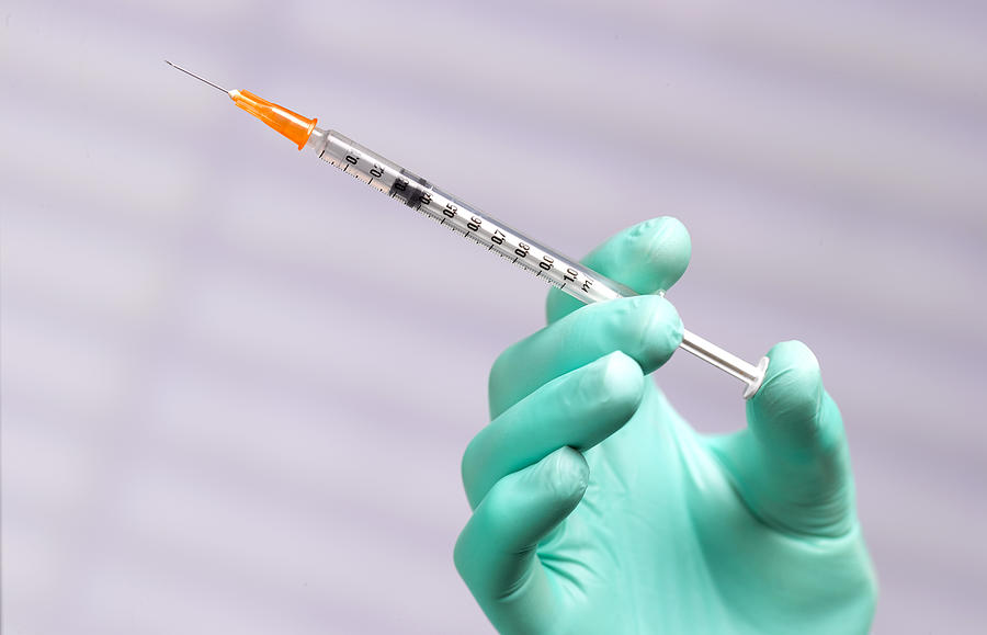 Vaccination syringe Photograph by Peter Dazeley